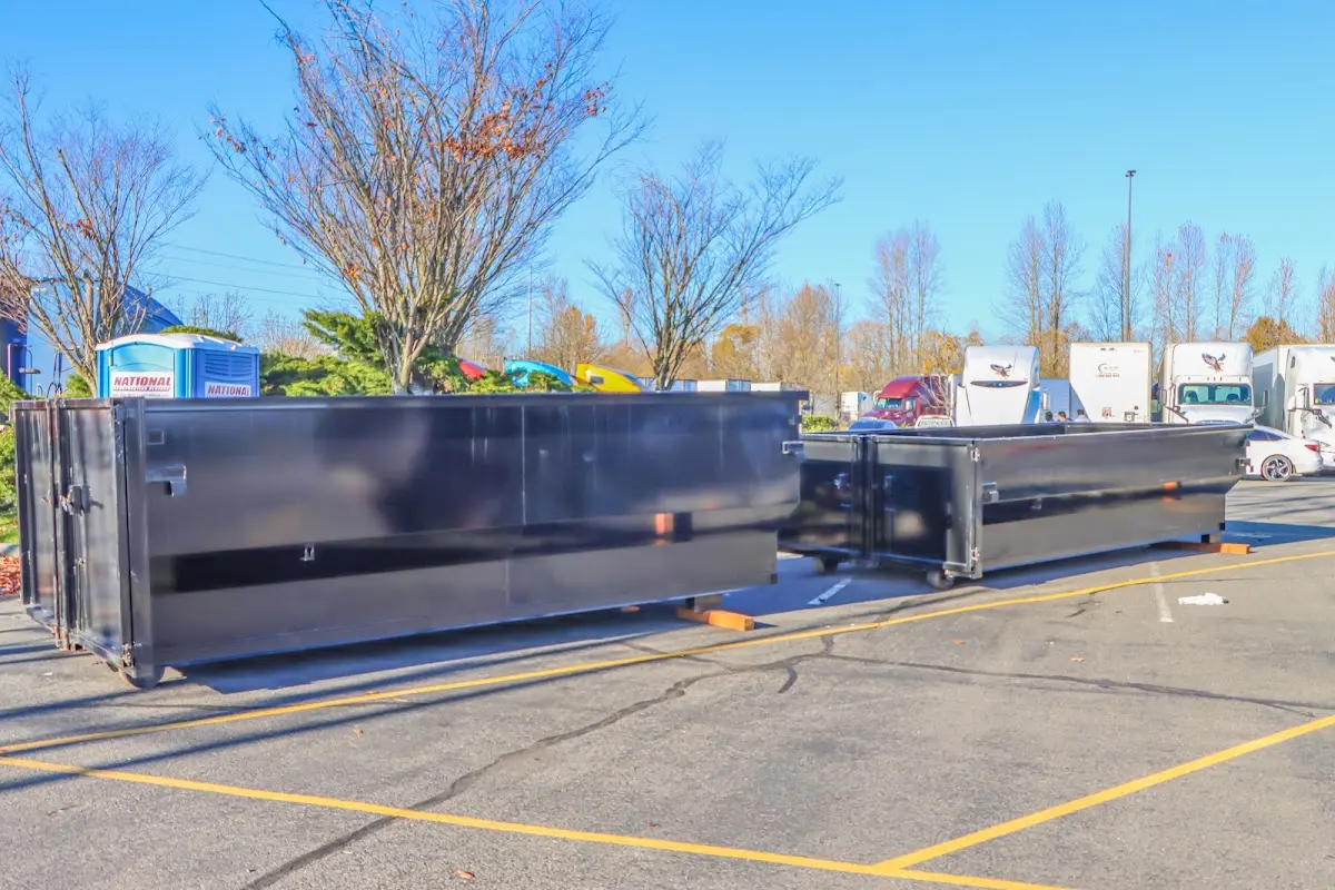 Professional dumpster rental service with roll-off container on residential driveway in Chackbay